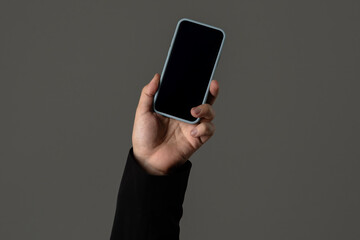 Hand Holding Modern Smartphone with Black Screen Display