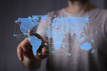 Person interacting with a digital world map, illustrating global connectivity and networking.