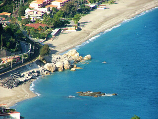 Beautiful aerial view of Taormina s coastline in Sicily, where vibrant blue Mediterranean waters...