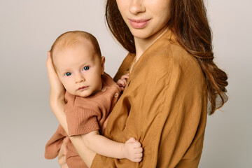 Joy shared between a beautiful young mother and her precious child in a warm, serene moment