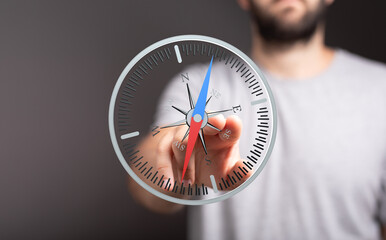 Conceptual image of a person using a digital compass, representing navigation, direction, and...