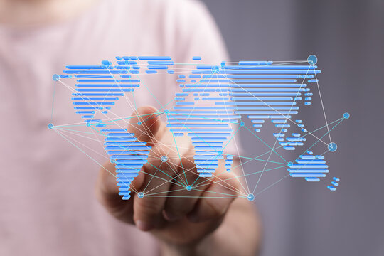 Person interacts with a digital world map showing global connections and networking.