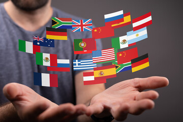 Image of diverse national flags floating above a person's hands, symbolizing global communication...