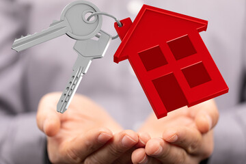 Image of house keys gently held, symbolizing new home ownership, real estate, and home buying.