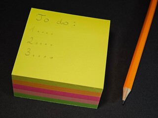 yellow sticky note with pencil, to-do list