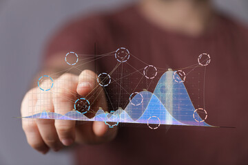 Person interacting with a digital graph showing business analytics and data visualization.