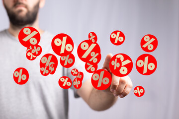 Image of a man interacting with digital percentage symbols, ideal for discount, sale, finance...