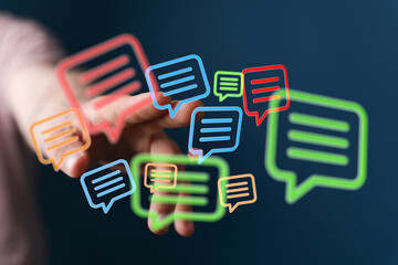 Hand interacting with vibrant speech bubbles,communication, messaging, social media, network, connection.