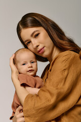 Beautiful young mother lovingly embraces her adorable child in a cozy indoor setting