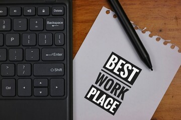 Notebook With 'Best Workplace' on Keyboard Signifying Professional Excellence