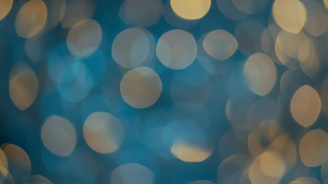 Abstract background of defocused blue and gold bokeh lights moving slowly