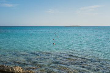 Red Safety Buoys Floating in Clear Blue Water at Rocky Entrance of Elafonisi Beach, Crete