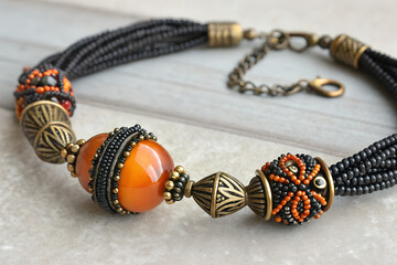 Handmade Beaded Necklace with Orange and Black Accents