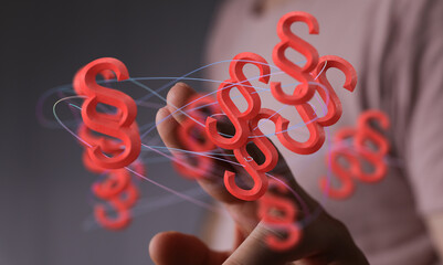 Abstract image of red paragraph symbols floating around a hand, representing legal concepts, law, and justice.