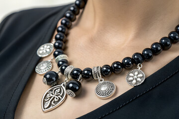 Elegant Black Beaded Necklace with Silver Charms