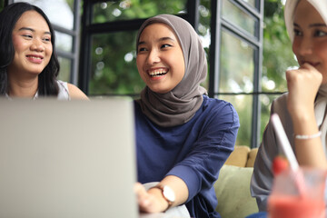 Group of Cheerful and Pretty Asian Female Friends are Hanging Out at a Cafe