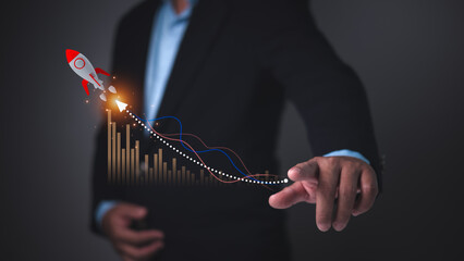 Businessman pointing at data graph with a rocket icon symbolizing rapid startup growth, business success, financial performance, innovation strategy, Accelerated market expansion for new ventures.