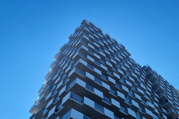 Modern Architectural Design of Abstract High-Rise Building Against Clear Blue Sky