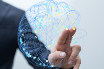 A hand interacts with a digital globe, symbolizing global networking, connection, and data...