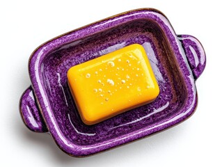 Natural Yellow Soap Bar in a Purple Ceramic Dish for Cleanliness