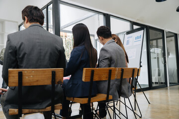 Corporate Gathering: A group of business professionals engages in a collaborative session, with...