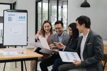 Collaboration and Analysis: A collaborative office scene with a diverse group of professionals, engaged in an analysis session, highlighting teamwork, communication, and data-driven decision-making.