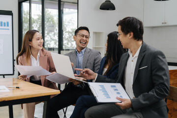 Business Professionals: collaborative meeting between business professionals focused on documents and presentations. Collaboration in workspace with a light, airy atmosphere. 