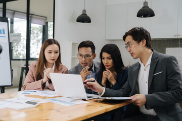 Business Colleagues Concentrating: A focused group of business associates is engrossed in a...