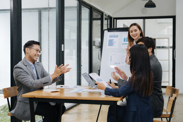 Team Meeting Collaboration: A diverse team engages in a productive meeting, reviewing data and collaborating on projects, showcasing effective communication and teamwork in a modern office setting.