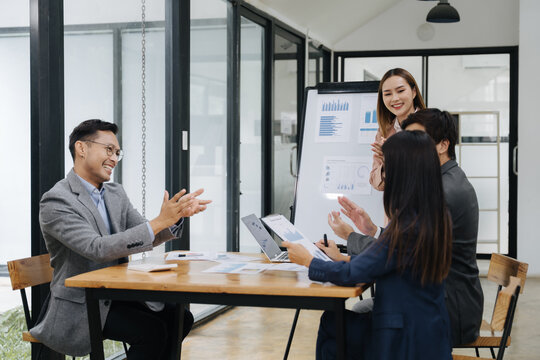 Team Meeting Collaboration: A diverse team engages in a productive meeting, reviewing data and collaborating on projects, showcasing effective communication and teamwork in a modern office setting.