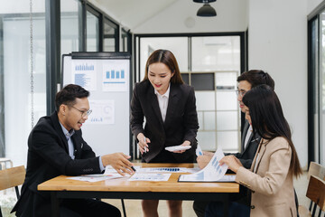 Focused Collaboration: A business team intently reviews data and strategies, their faces reflecting deep concentration and cooperative effort.