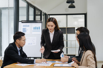 Leadership in Action: A decisive leader guides a focused team in a dynamic business meeting,...