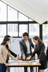 Teamwork for Success: Team of Colleagues Standing Around a Table During Corporate Meeting.