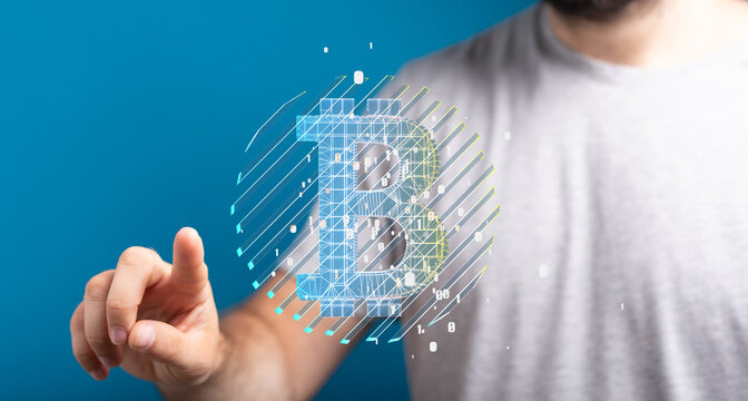 Person touching a digital Bitcoin symbol, representing cryptocurrency and blockchain technology.