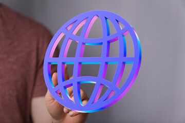 Person holding a vibrant 3D globe icon, symbolizing internet connectivity and global reach.