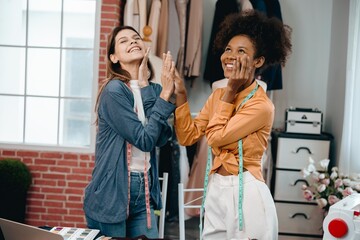 two women designer discusses and exchange ideas for clothing design with intention and happiness.