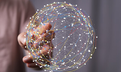 Abstract image of a hand interacting with a digital global network. Represents connection,...