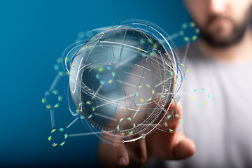 Man interacts with a digital globe, showcasing global network and technology connections.