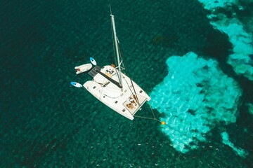 Aerial view of a catamaran in turquoise waters.