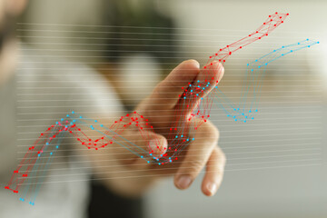 Stock photo depicting a hand interacting with a dynamic graph, showcasing financial growth and data...