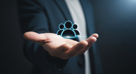 Businessman holding digital icons of people and team management, representing human resources, recruitment, employee data, business leadership, 