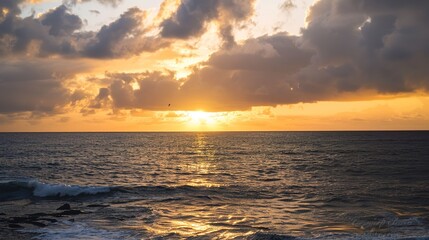 Fototapeta premium Stormy Cloudy Ocean Sunset with Dramatic Cumulonimbus Clouds and Turquoise Waves, Overcast Seascape Featuring Amber Glow Through Cloud Breaks and Empty Horizon