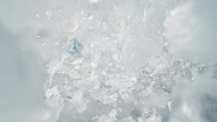 Super Slow Motion Shot of Ice Pieces Flying Towards Camera on Light Background at 1000fps. - Powered by Adobe