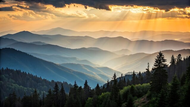 Sunbeams pierce through dramatic clouds illuminating layers of misty blue mountain ranges at sunrise