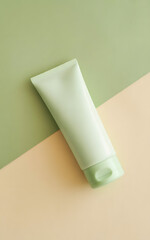A green cosmetic cream tube isolated on a pastel background