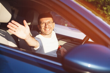 Happy guy in a car. Auto test-drive, leasing, buying, renting concept
 
