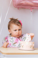 Child girl eating birthday cake