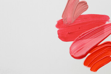 Samples of different lipsticks on white background, flat lay. Space for text