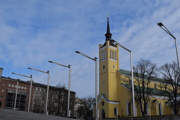 Yellow Church with Modern Streetlights in Tallinn Cityscape