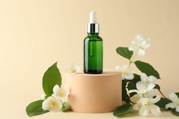 Cosmetic product and jasmine flowers on beige background